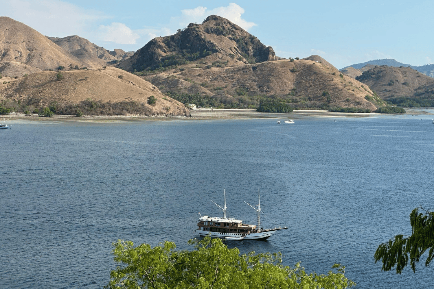 Wooden boat anchored in a calm bay in Komodo National Park