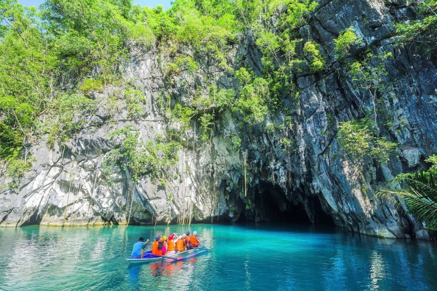 A group of people in a boat near cave in Palawan