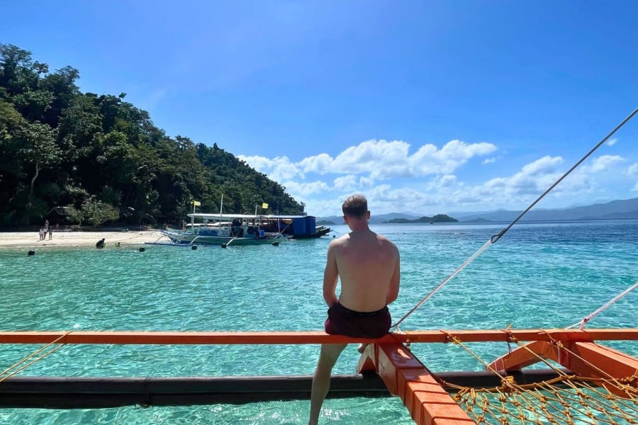 Traveller sat on a boat in the Philippines
